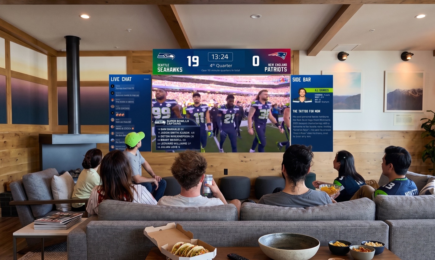 A group of friends on a couch watching Super Bowl LX on a wide projected wall with live chat and player-profile canvases flanking the game.